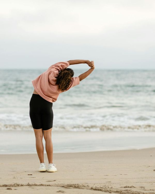 Person stretching gently, looking refreshed and energized.